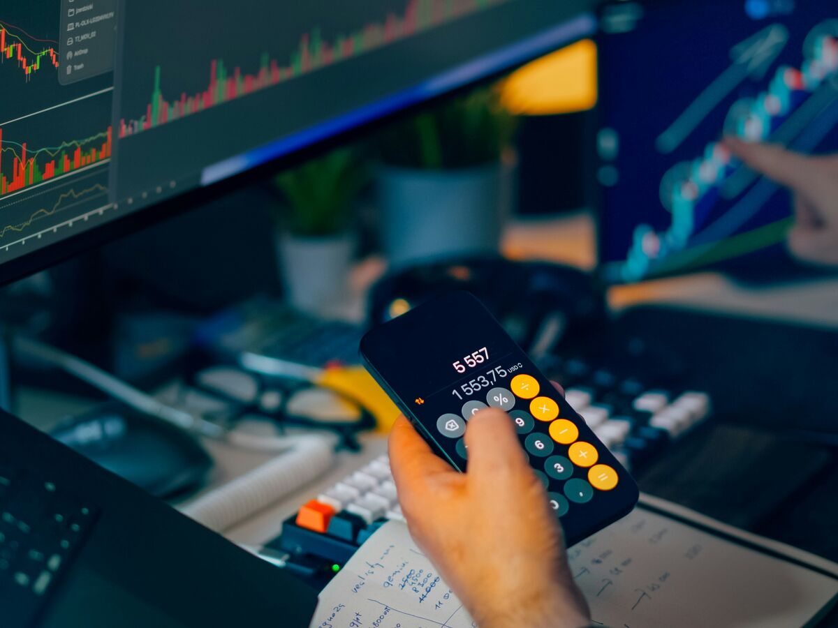 Analyst watching market data across a row of trading terminals